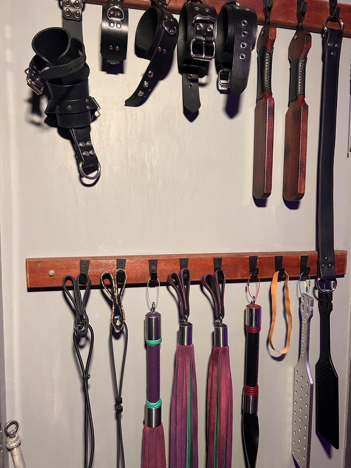 Cuffs and collars, by the wall.